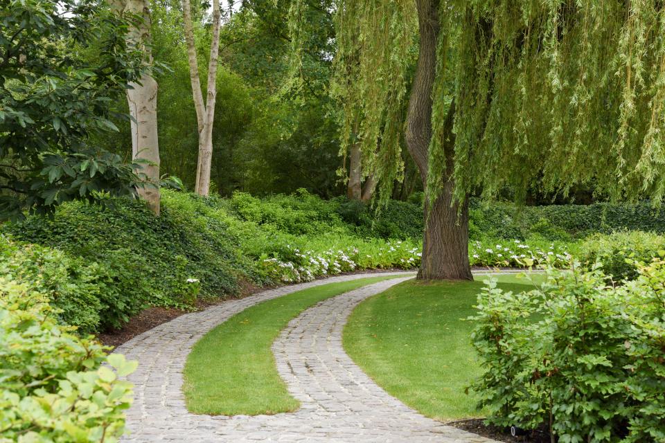 Een sfeervol kasseienpad met grasvoeg leidt je op een natuurlijke manier naar de woning.